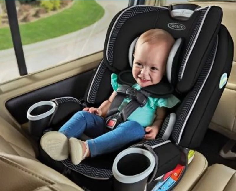 Toddler in a car seat, smiling, with safety features highlighted for shopping article
