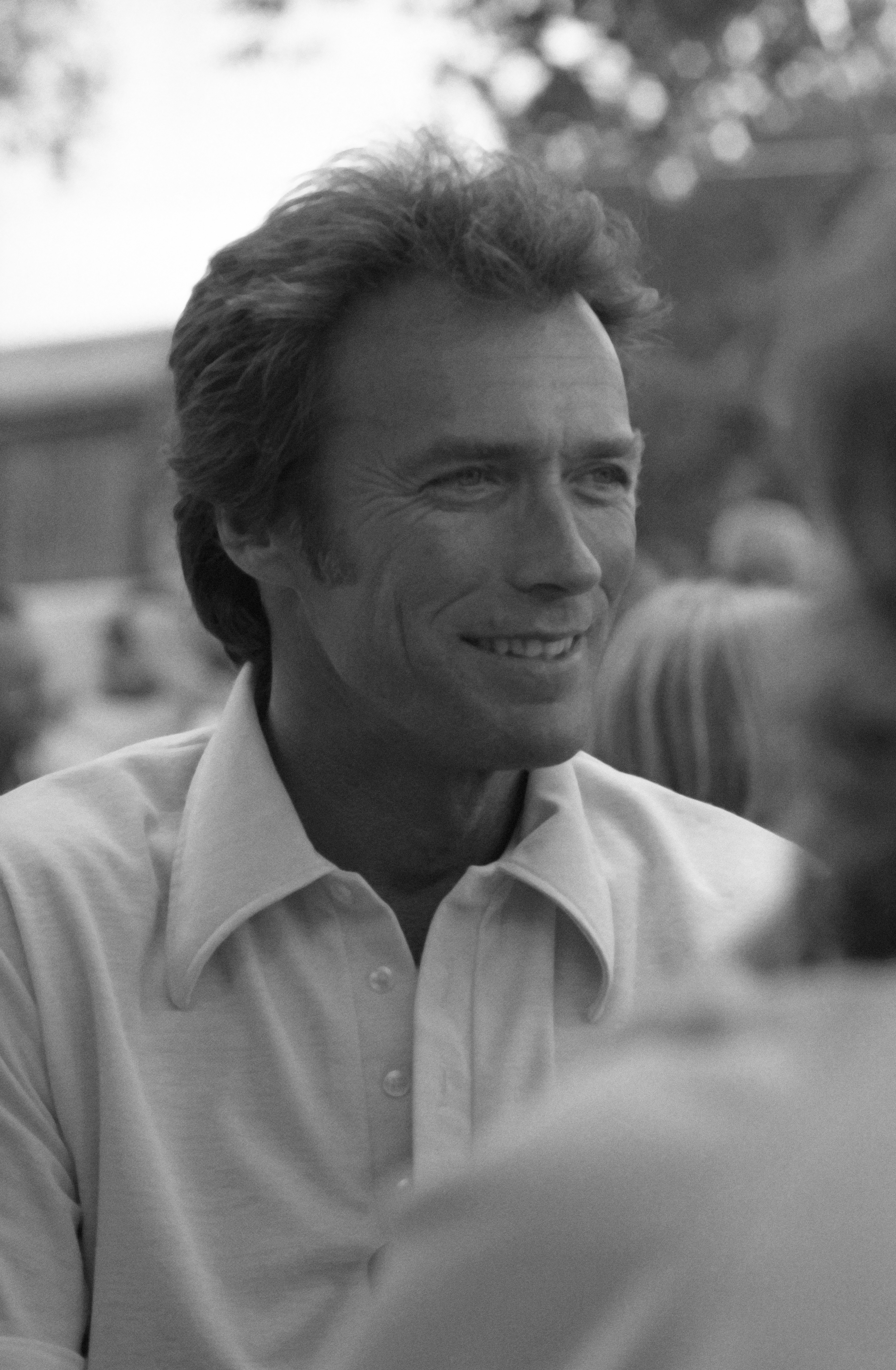 Clint smiling in casual shirt at an outdoor event