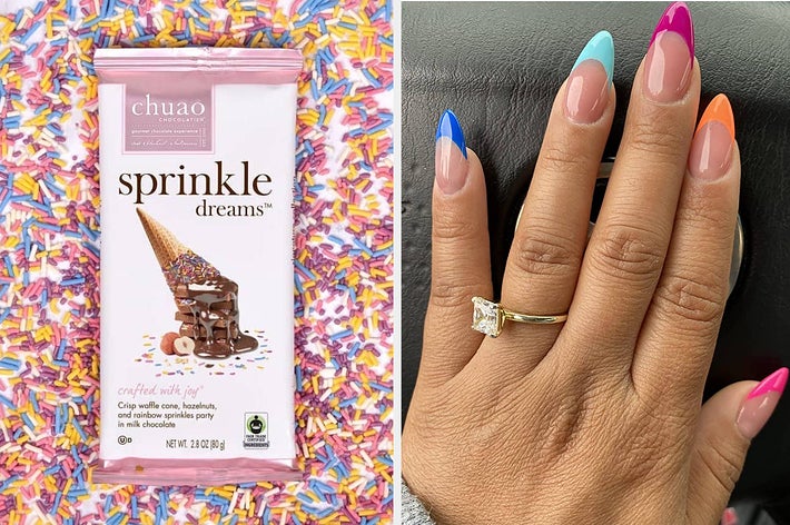 Hand with multicolored manicure holds Chuao Sprinkle Dreams chocolate bar with a confetti background