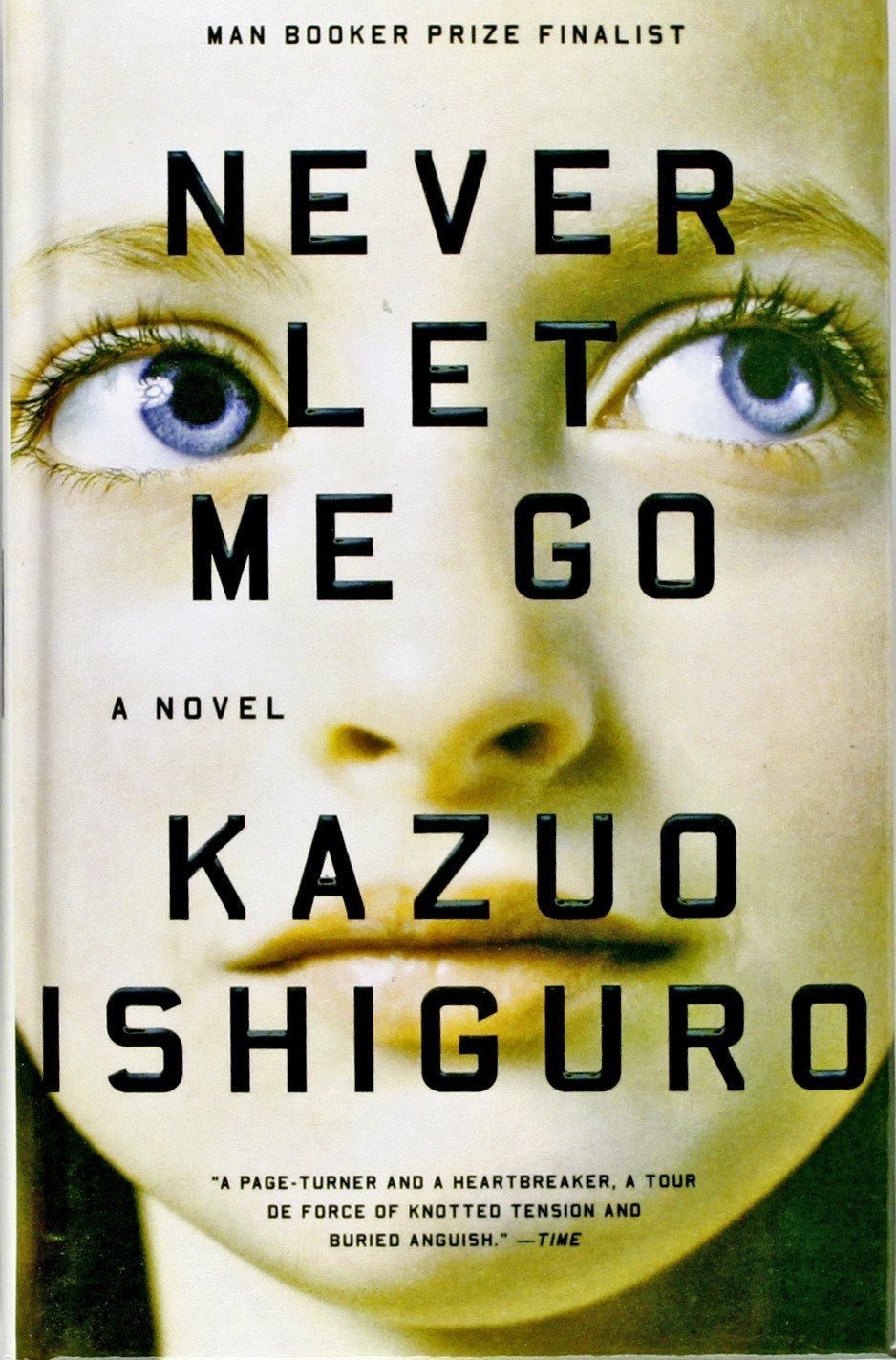 Close-up of &#x27;Never Let Me Go&#x27; book cover by Kazuo Ishiguro, featuring title and author&#x27;s name with a pair of eyes