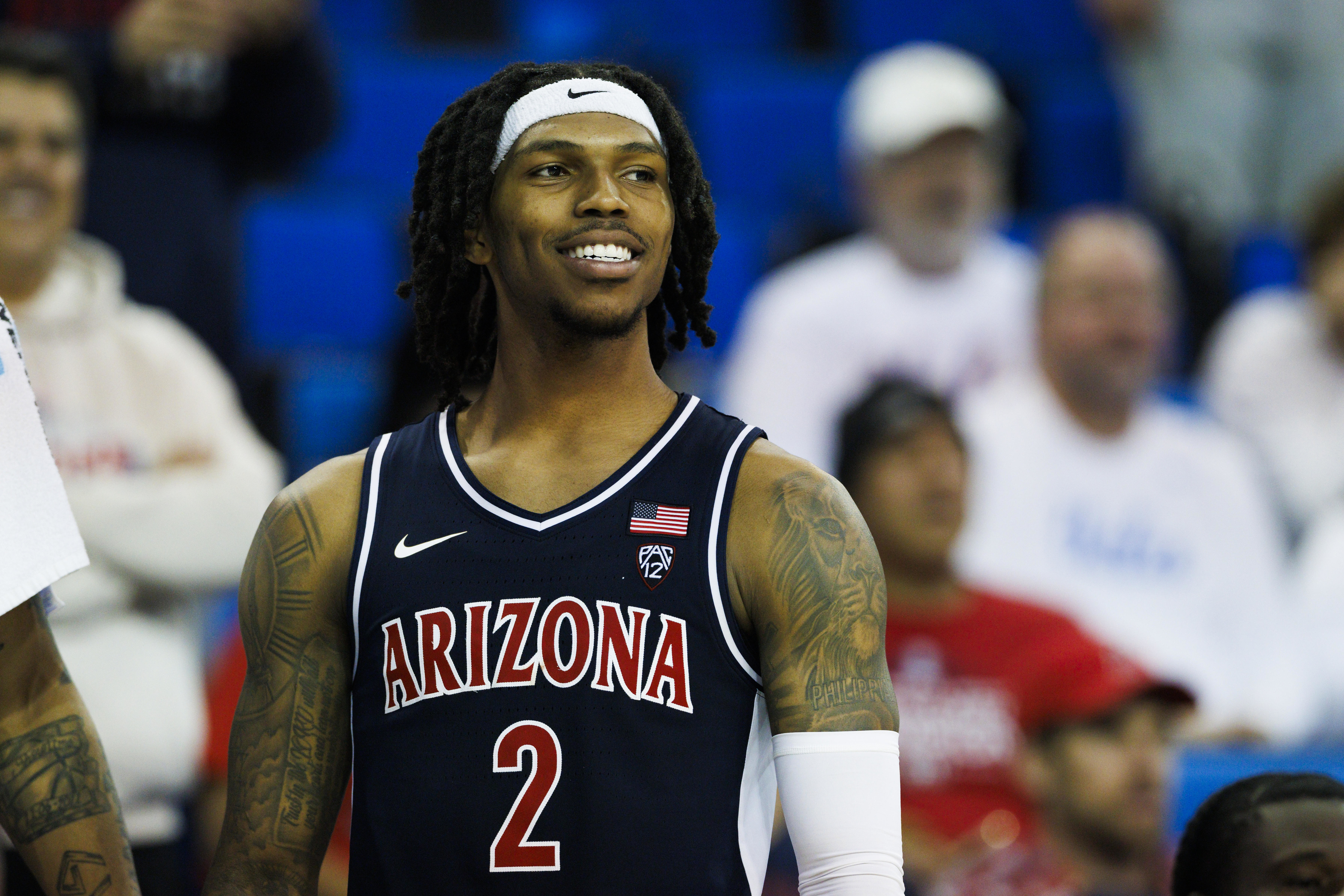 Basketball player in an Arizona jersey smiles during a game