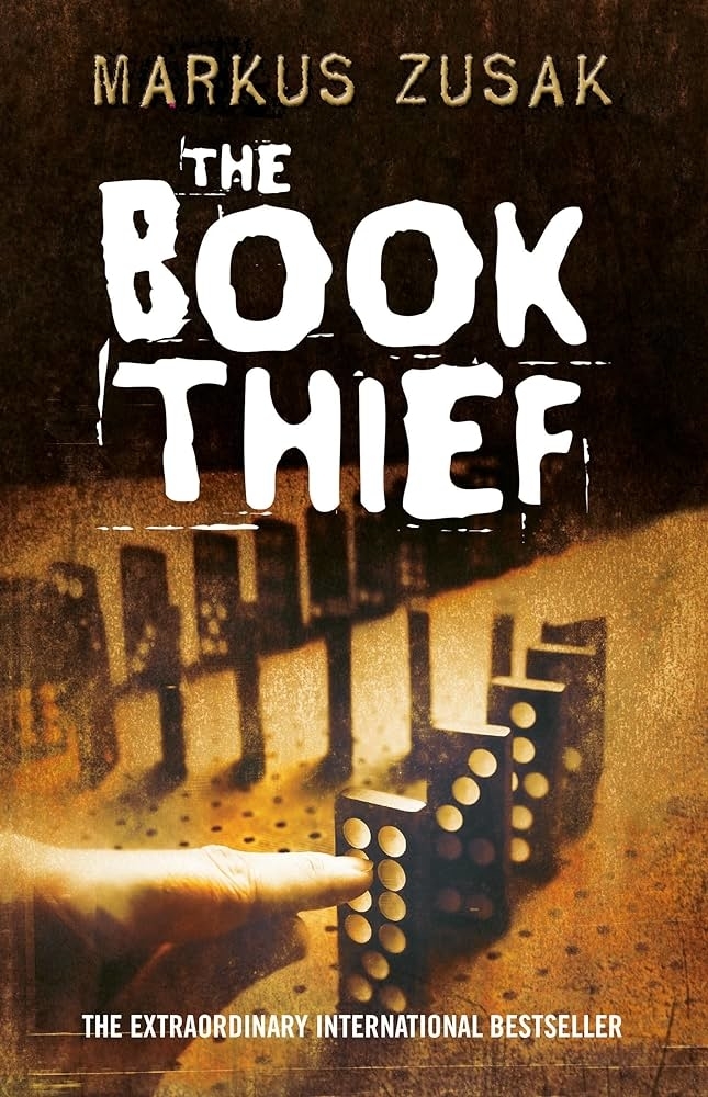 Cover of &quot;The Book Thief&quot; by Markus Zusak, featuring dominoes and a city silhouette