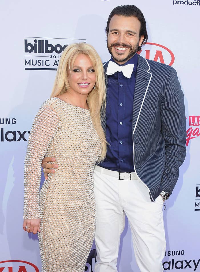 Britney and Charlie pose together at an event; she wears a mesh dress and he&#x27;s in a striped blazer and bow tie