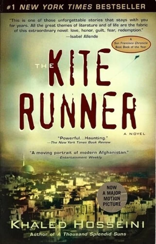 Book cover of &quot;The Kite Runner&quot; by Khaled Hosseini with accolades and a cityscape below the title