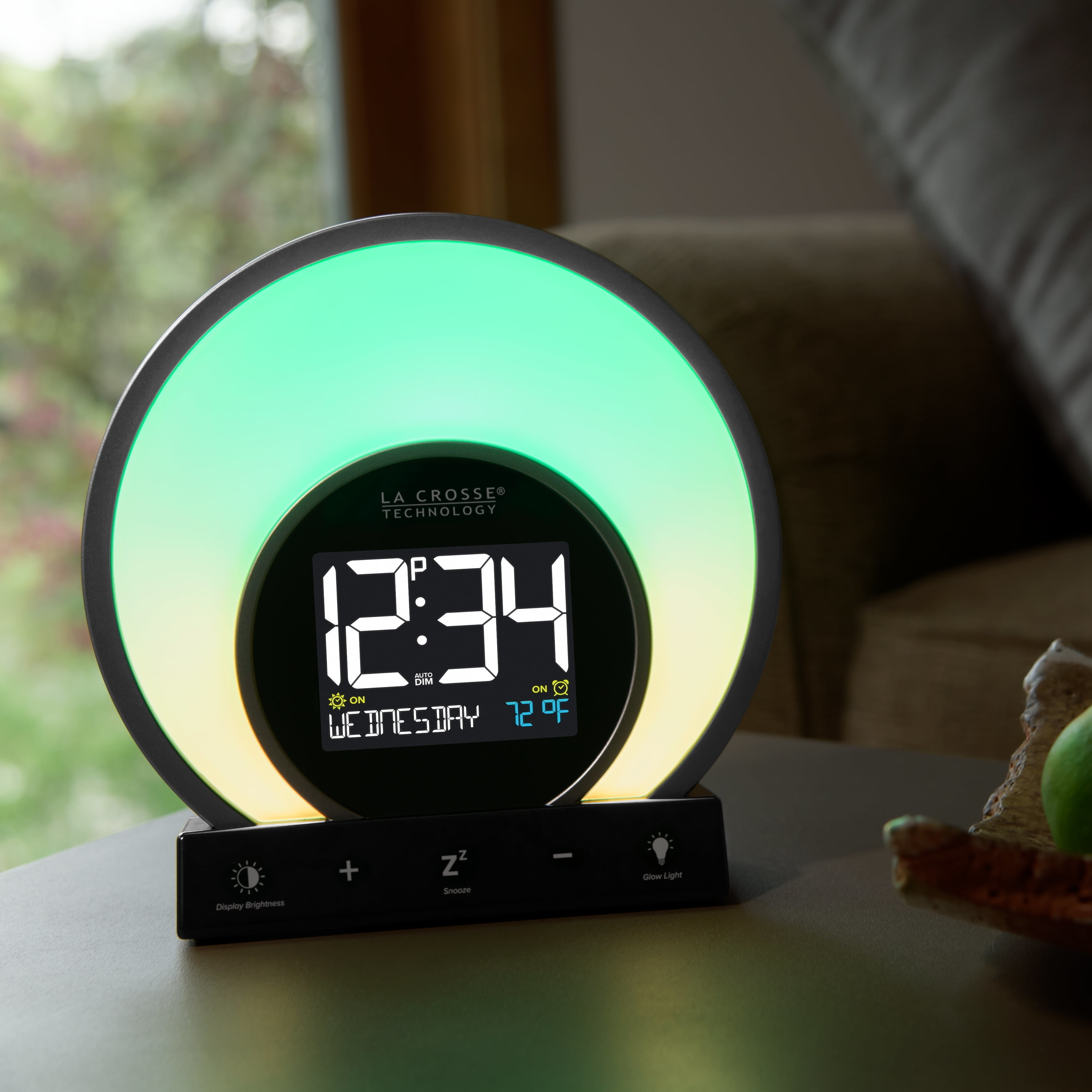 La Crosse Technology clock displaying time and temperature, with adjustable light ring placed on a table