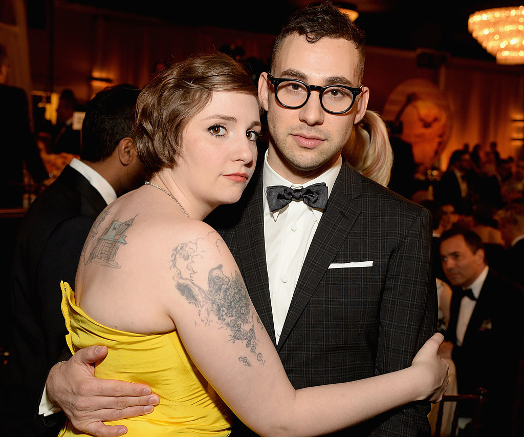 Lena in a strapless yellow dress with a tattoo on her arm, and Jack in a suit with a bow tie, hugging each other