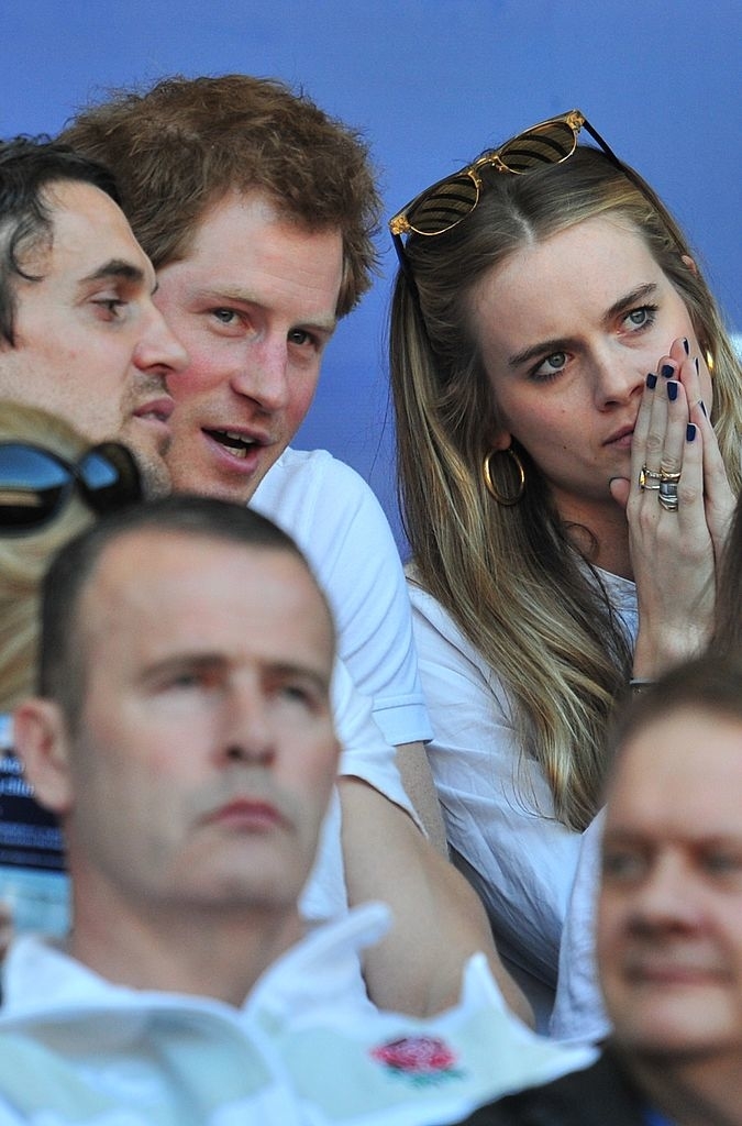 Prince Harry and Cressida in the audience at a sporting event, both looking attentive