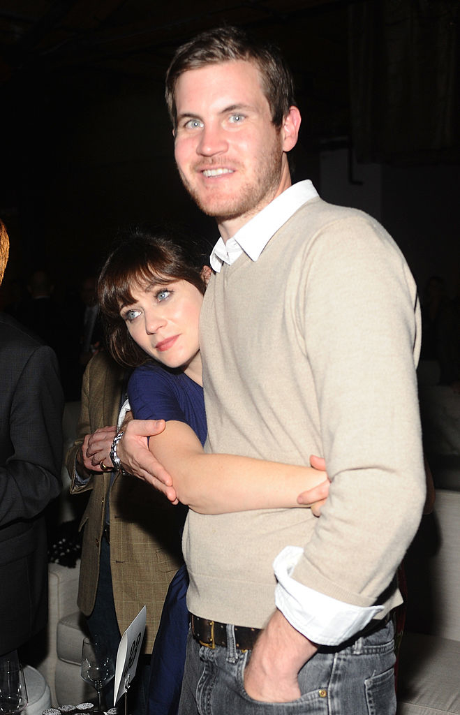 Zooey is hugging Jamie&#x27;s waist and his arm is around her
