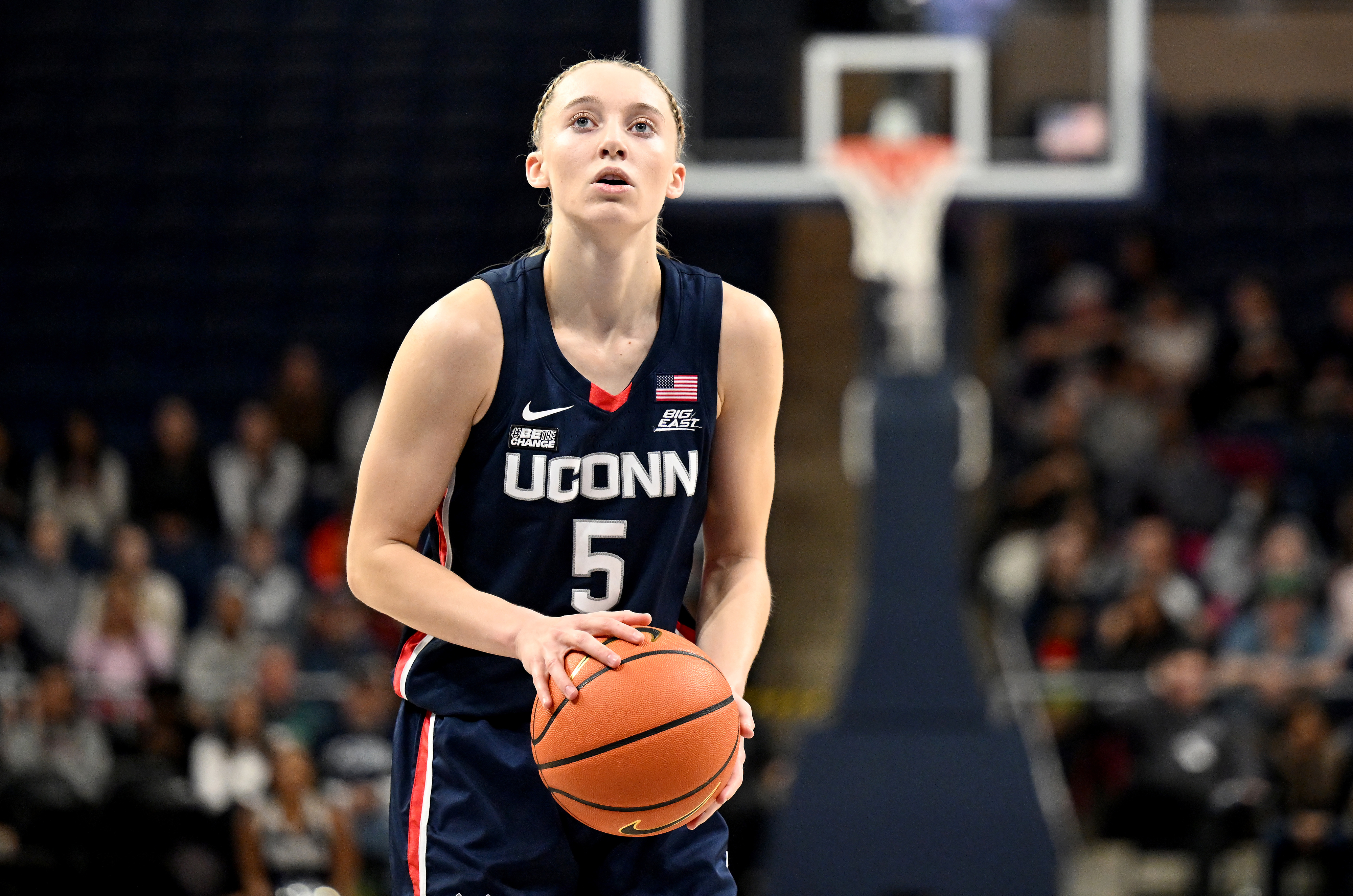 Female basketball player in UCONN uniform prepares for a free throw during a game