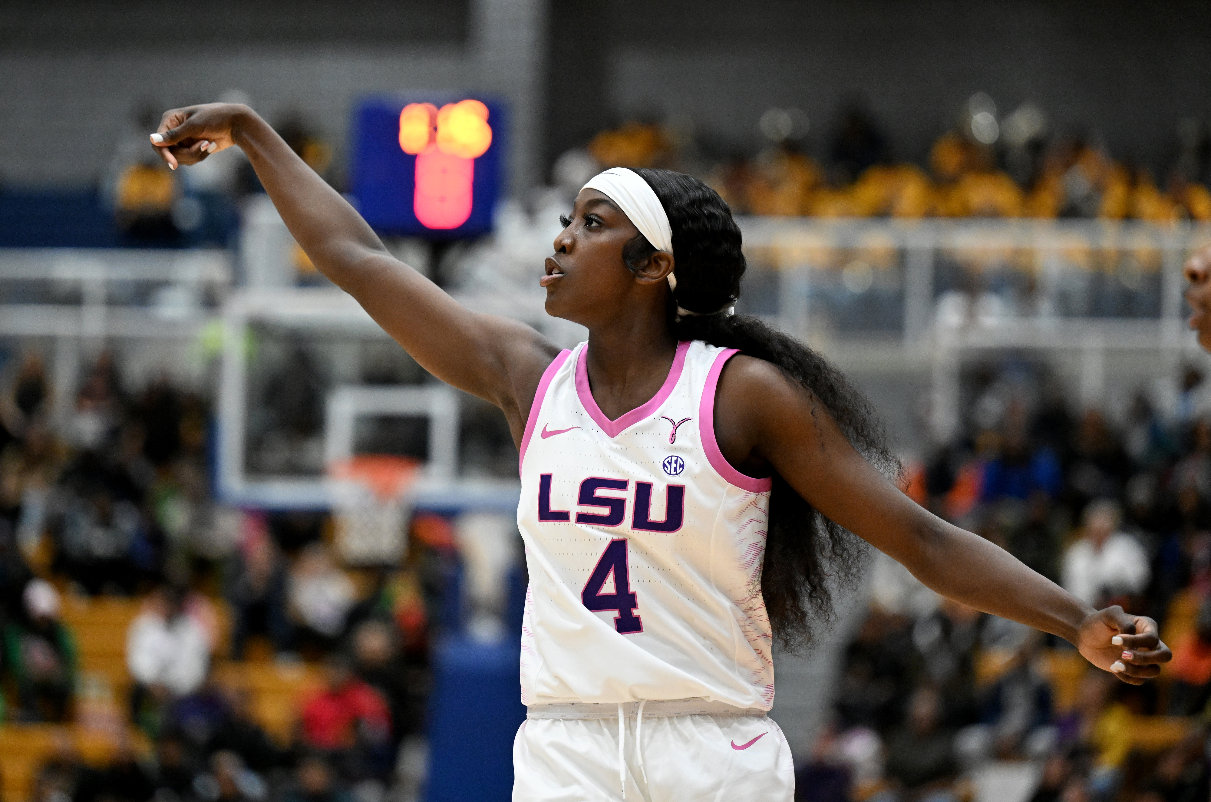 LSU basketball player in action on the court, wearing team uniform with the number 4