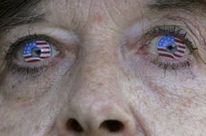 Close-up of a person with American flag contact lenses in their eyes