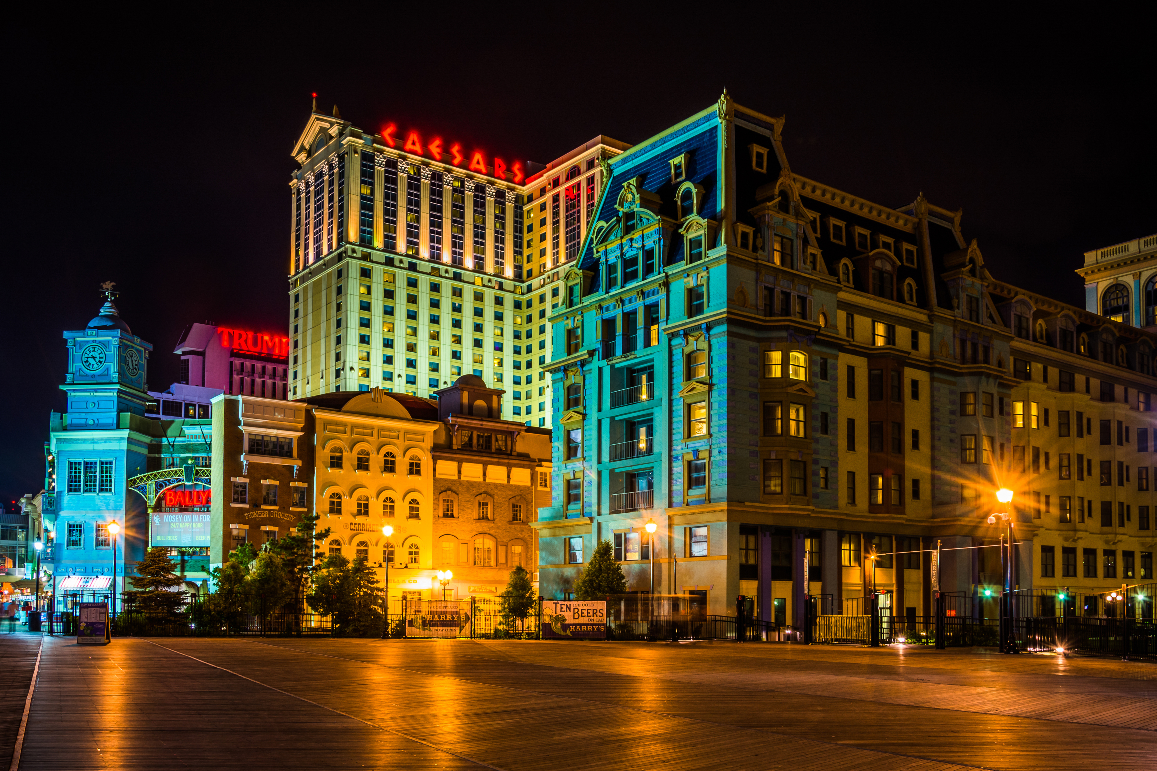 Nighttime view of the Caesar&#x27;s and Trump Plaza buildings with illuminated signage