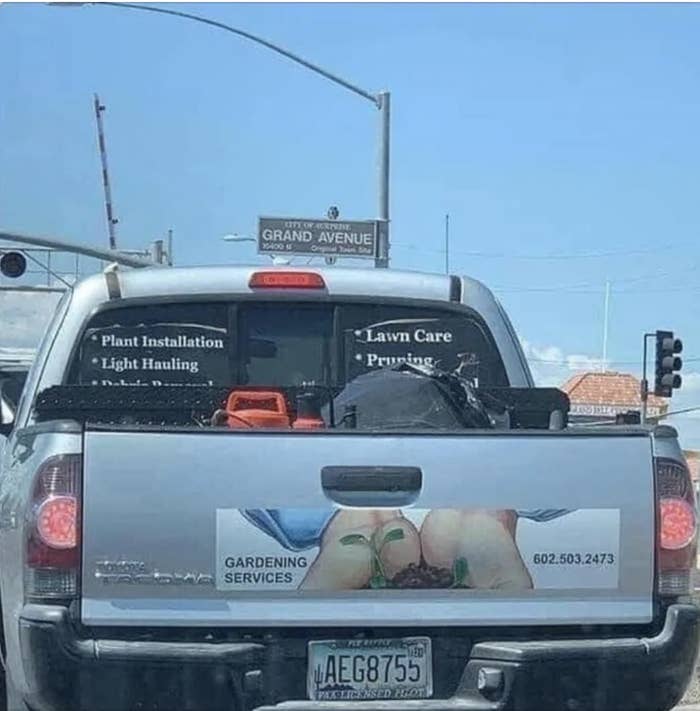 A gardening services sticker on a car that looks like two butts together
