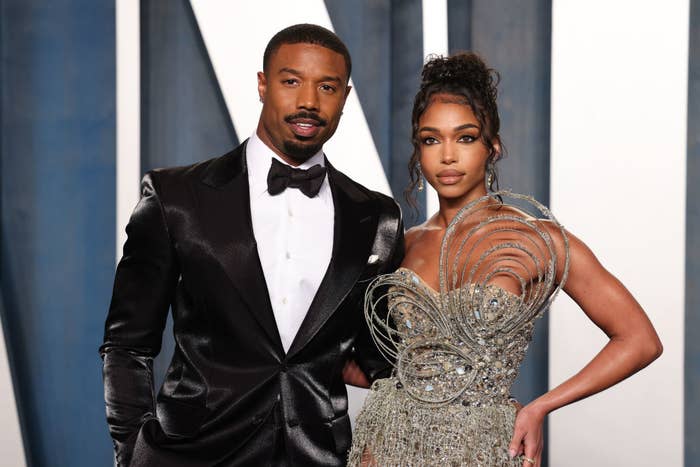 Michael and Lori posing, person on left in a black tuxedo, right in a metallic embellished gown