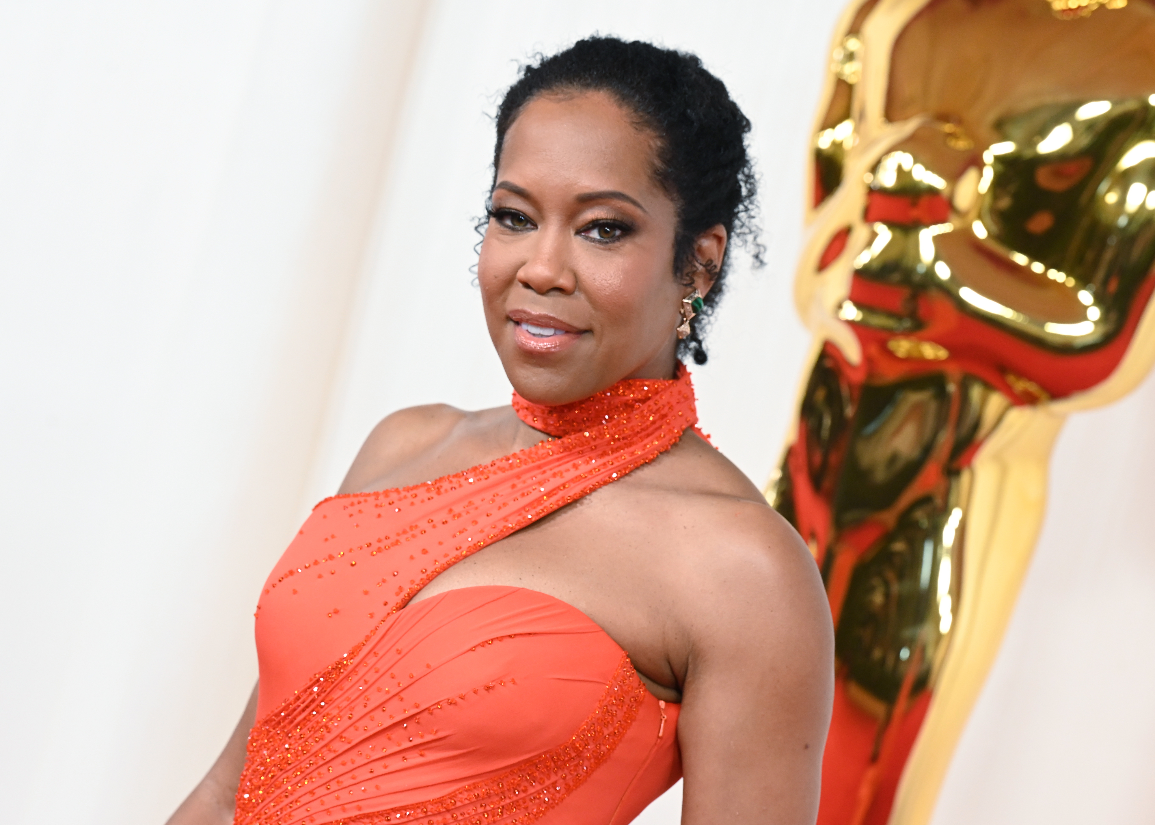 Regina King in a one-shoulder, beaded gown at an awards event
