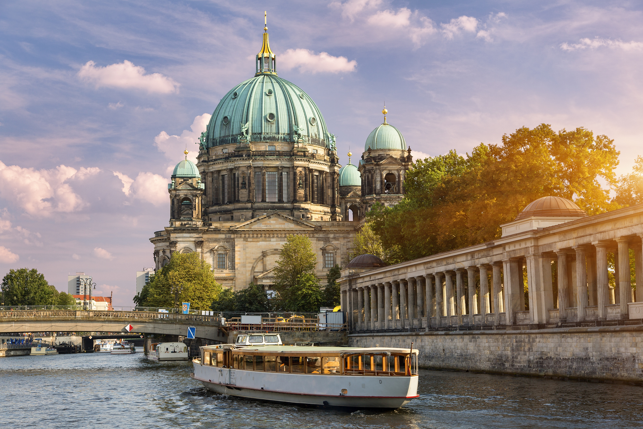 Berlin Cathedral by the Spree river with a passing tour boat in the foreground