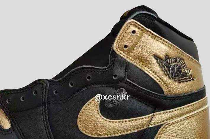 Close-up of a black and gold Air Jordan 1 sneaker from the side