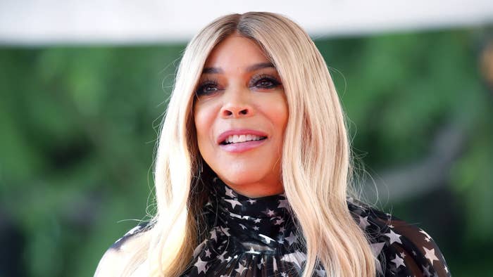 Wendy Williams in a star-patterned outfit smiling at an event