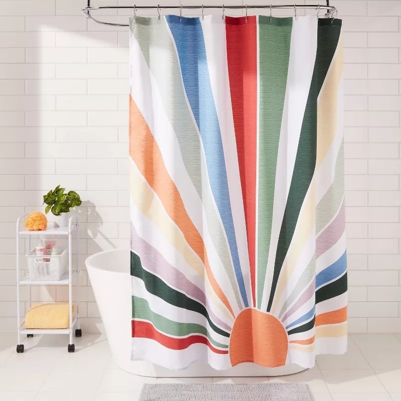 A shower curtain with a multi-colored sunburst pattern