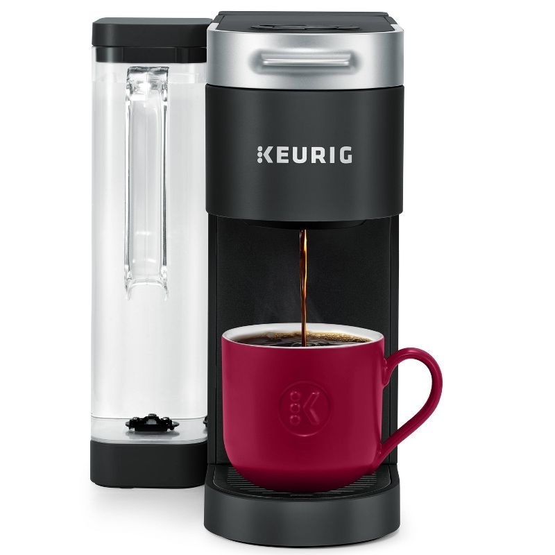 The black Keurig brewing a cup of coffee