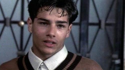 Close-up of a character from a film featuring a young man with a retro hairstyle and a striped sweater