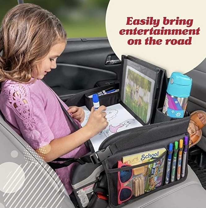 Child in car seat using a backseat organizer with tablet holder and drawing supplies