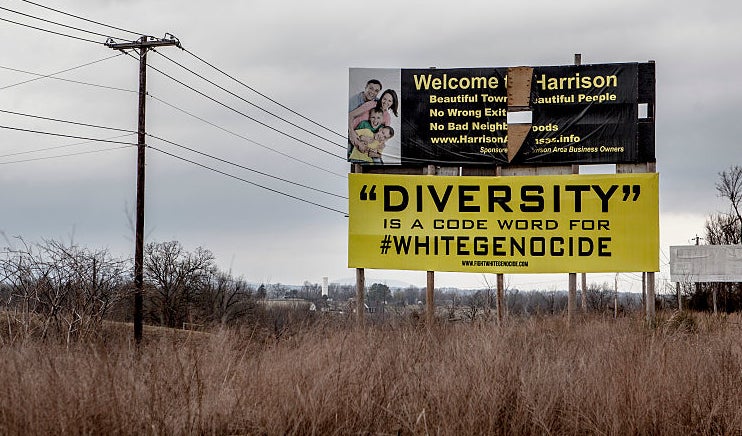 Billboard in a field with provocative message on diversity and website URL