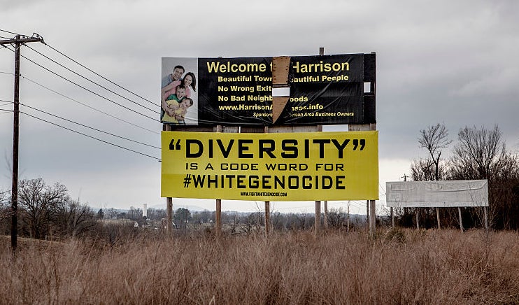 Billboard in a field with provocative message on diversity and website URL