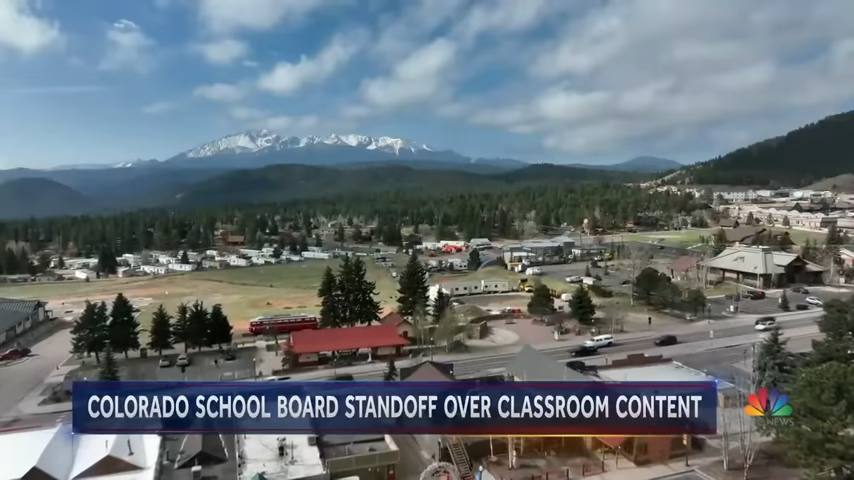 Aerial view of a town with the caption &quot;Colorado School Board Standoff Over Classroom Content&quot;