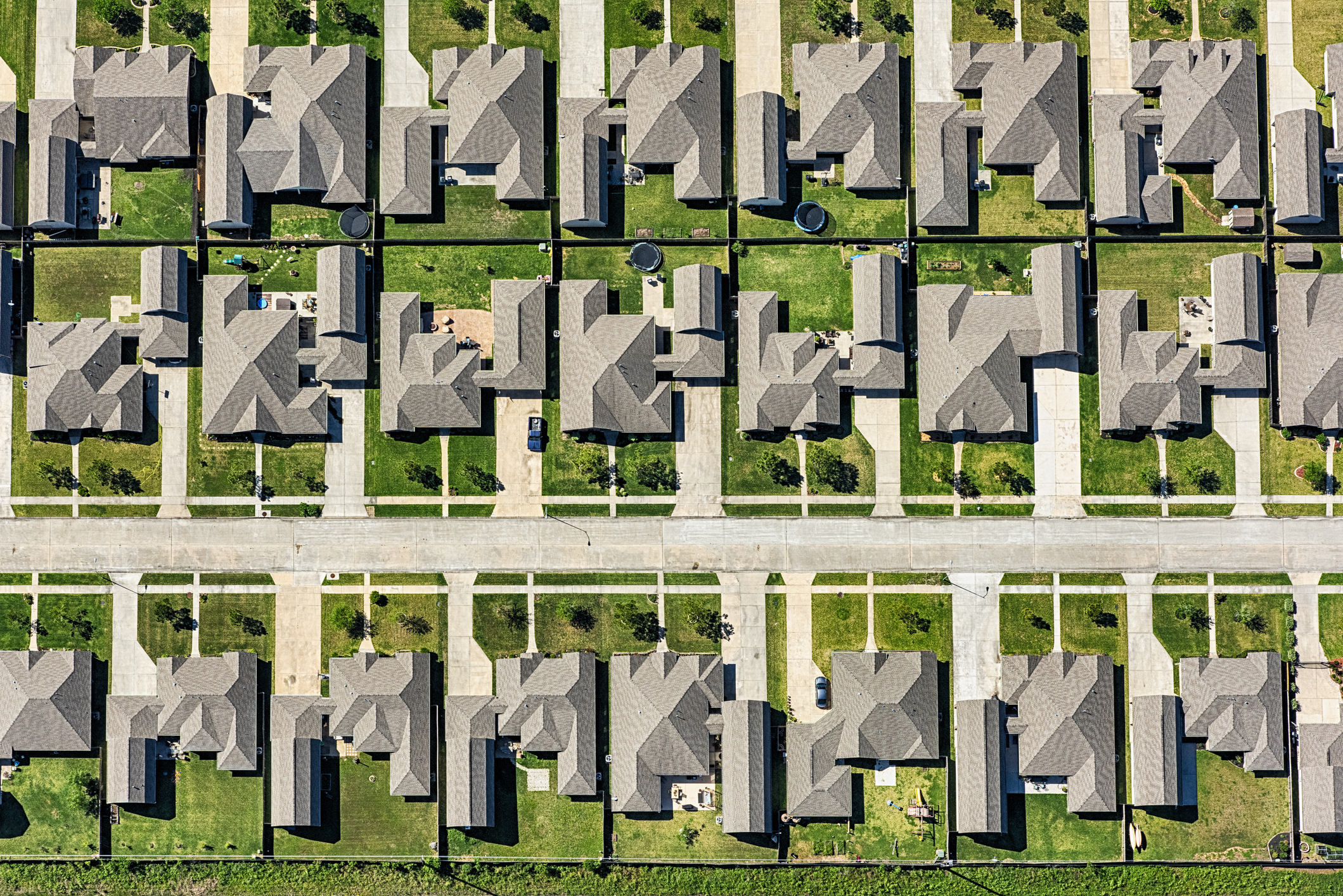 Aerial view of a suburban neighborhood with uniform houses and tidy yards