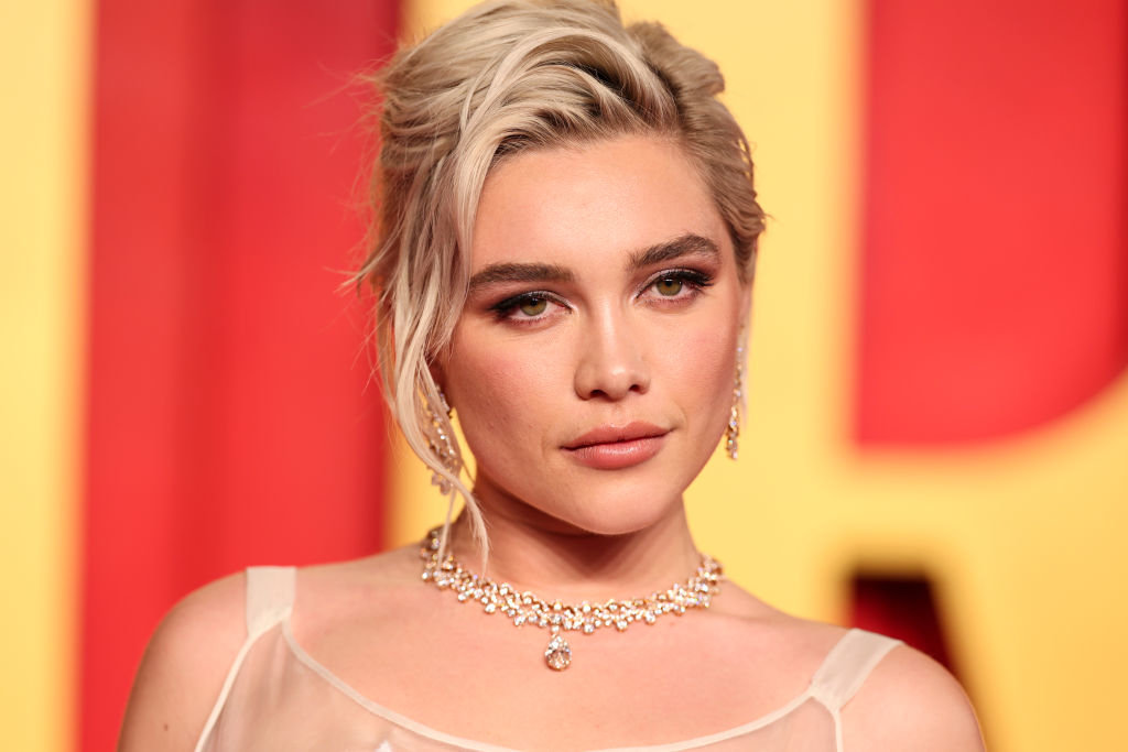 Woman in elegant attire with a necklace, at an event