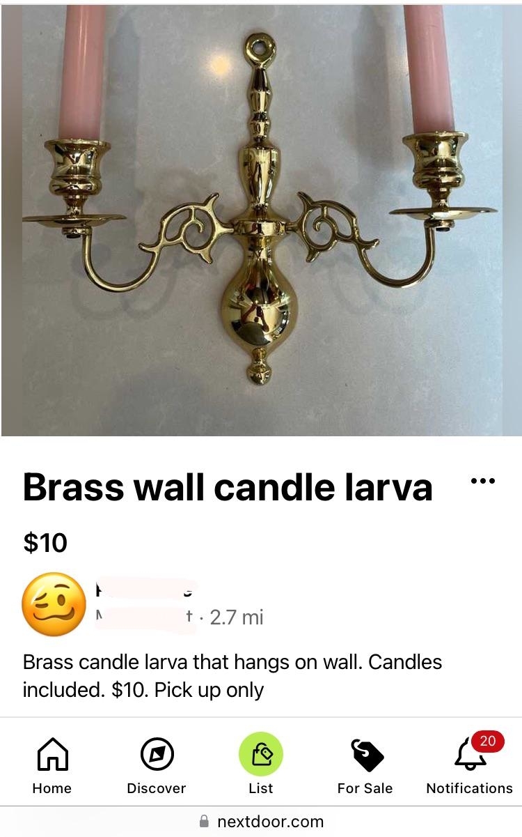 Brass wall-mounted candle holder with pink candles, advertised for $10 as &quot;brass candle larva that hangs on wall&quot;