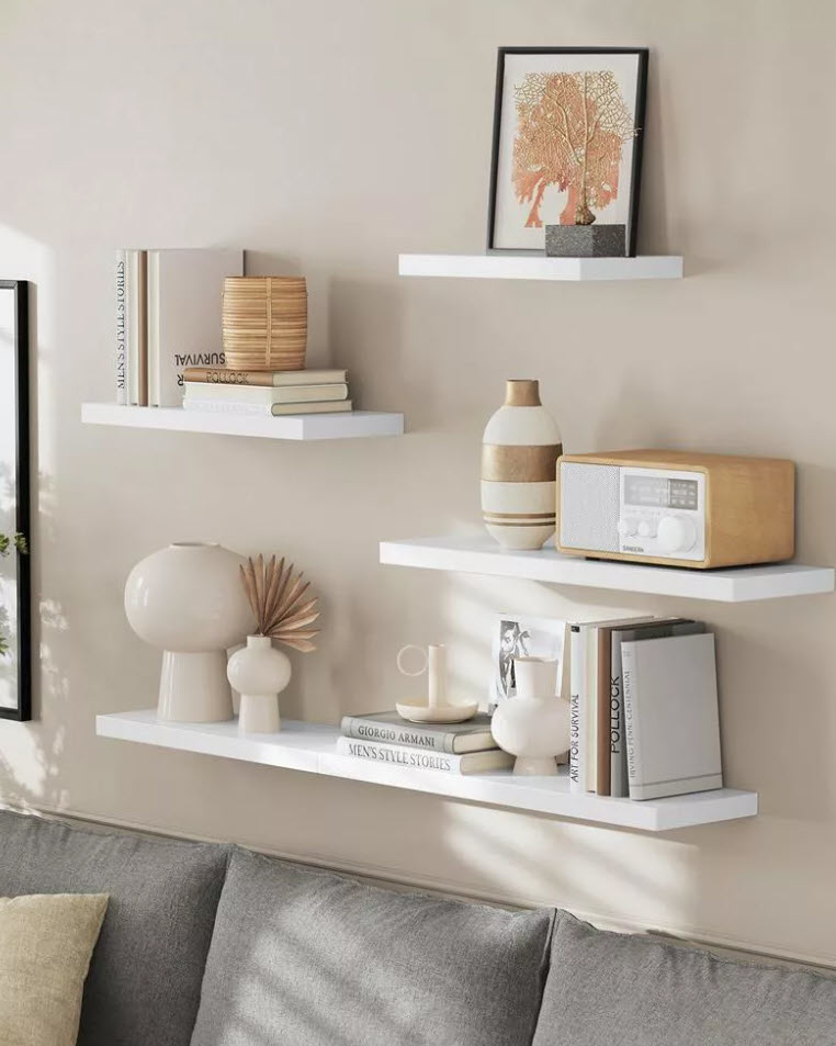 Wall shelves with decorative items including books, vases, a radio, and framed artwork