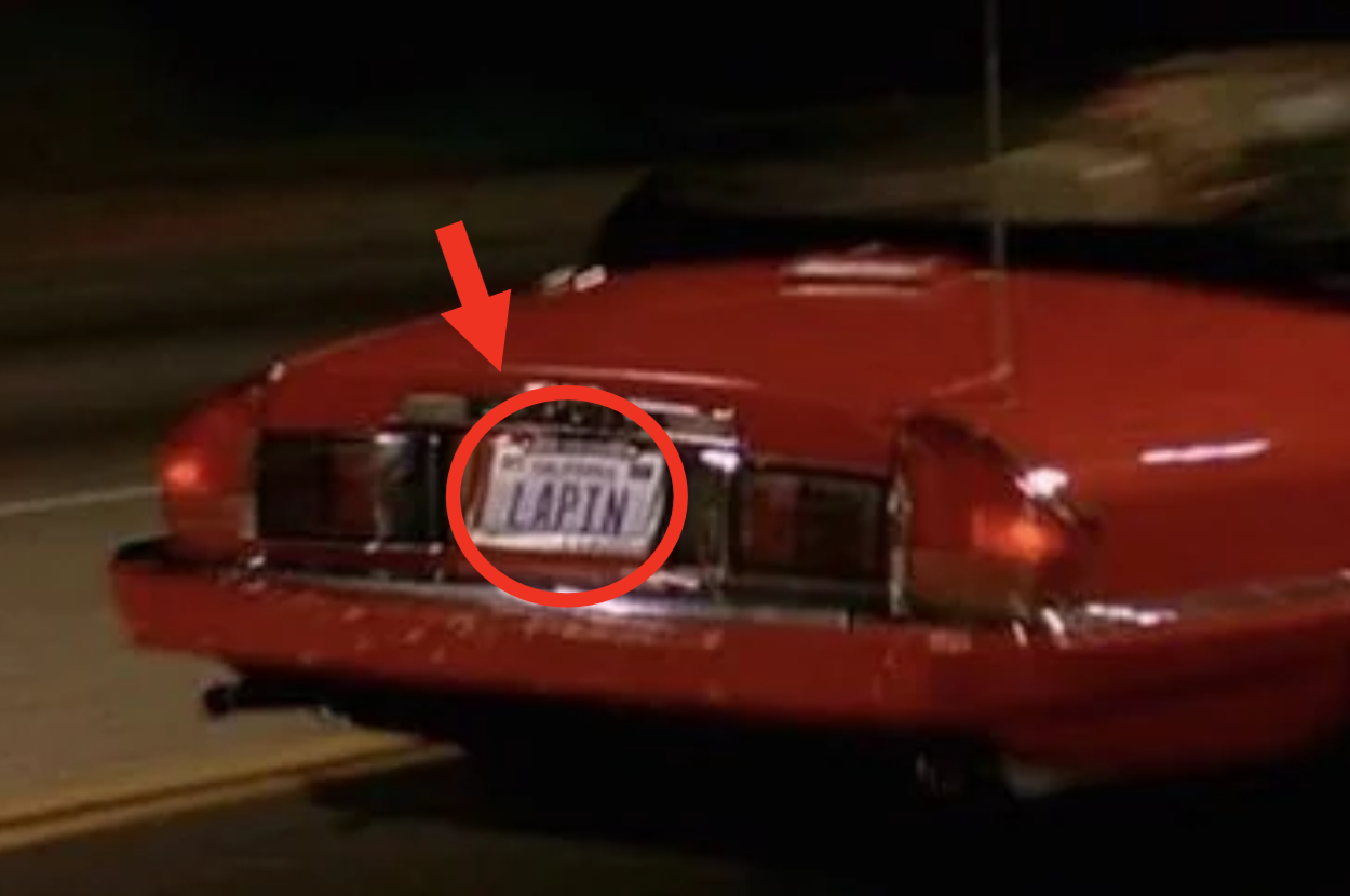 Rear view of a car with the license plate reading &quot;LAPIN&quot; at night