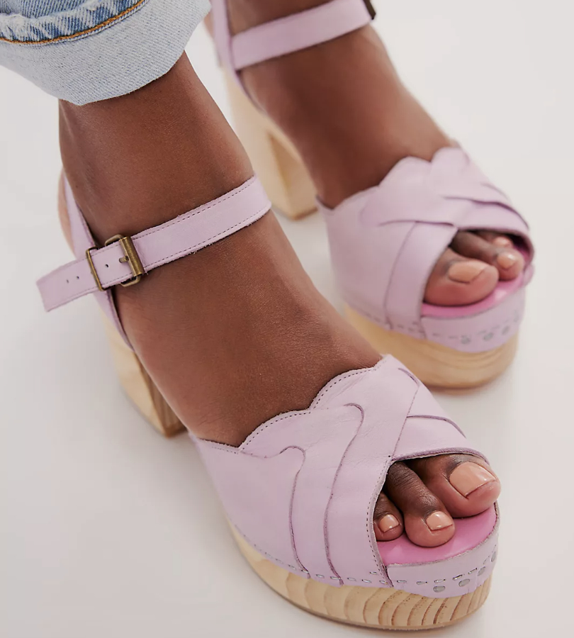 Close-up of a person&#x27;s feet wearing pink platform sandals with buckle