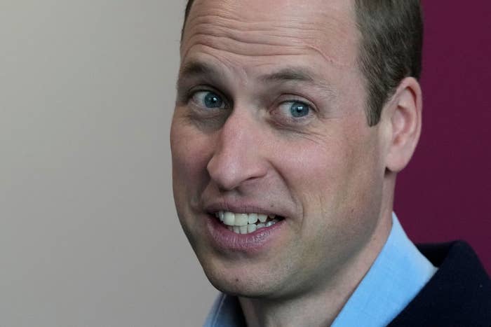 Close-up of Prince William smiling in a suit at a public event