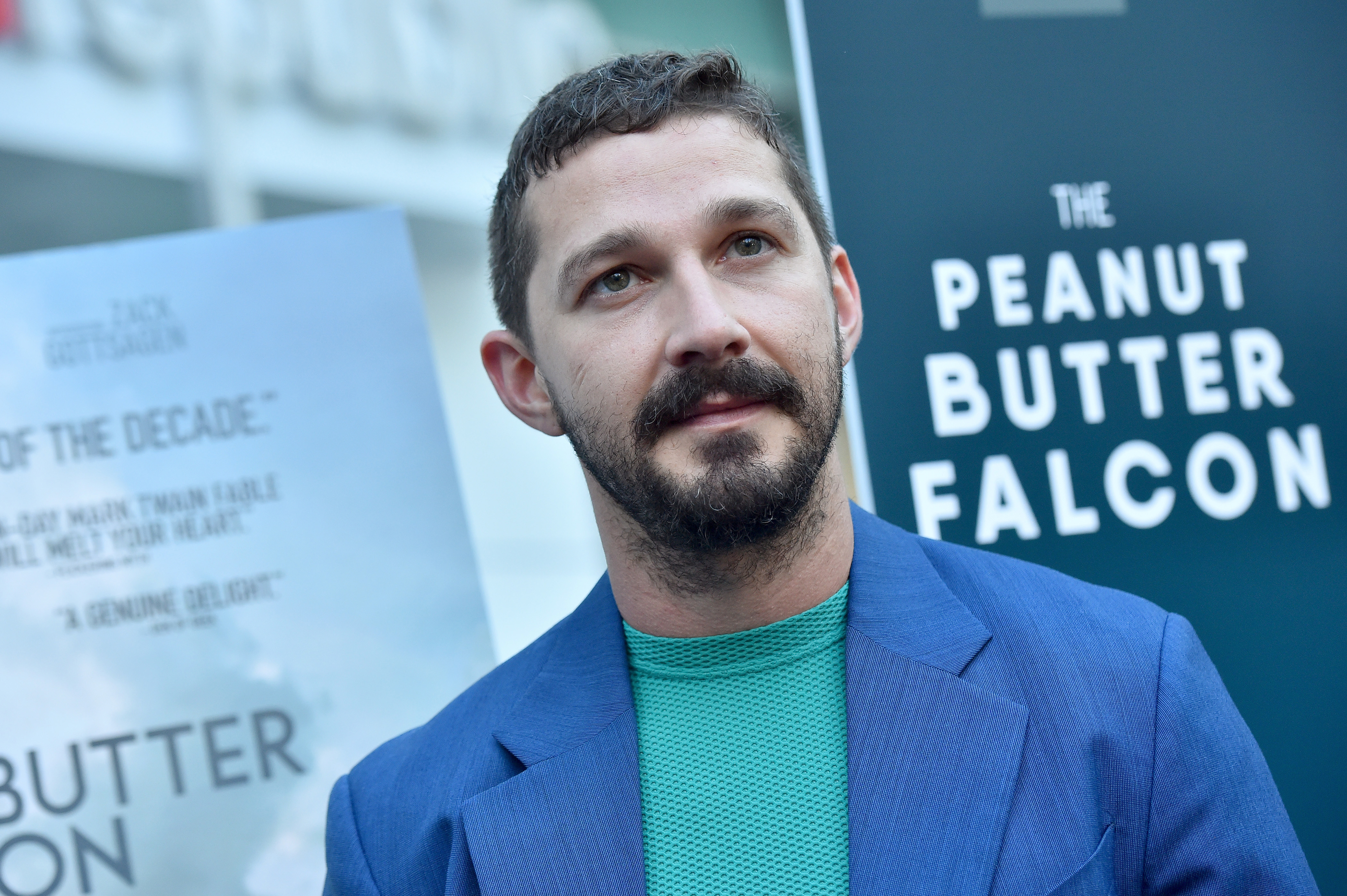 Shia LaBeouf in a blue suit without a tie at &quot;The Peanut Butter Falcon&quot; premiere