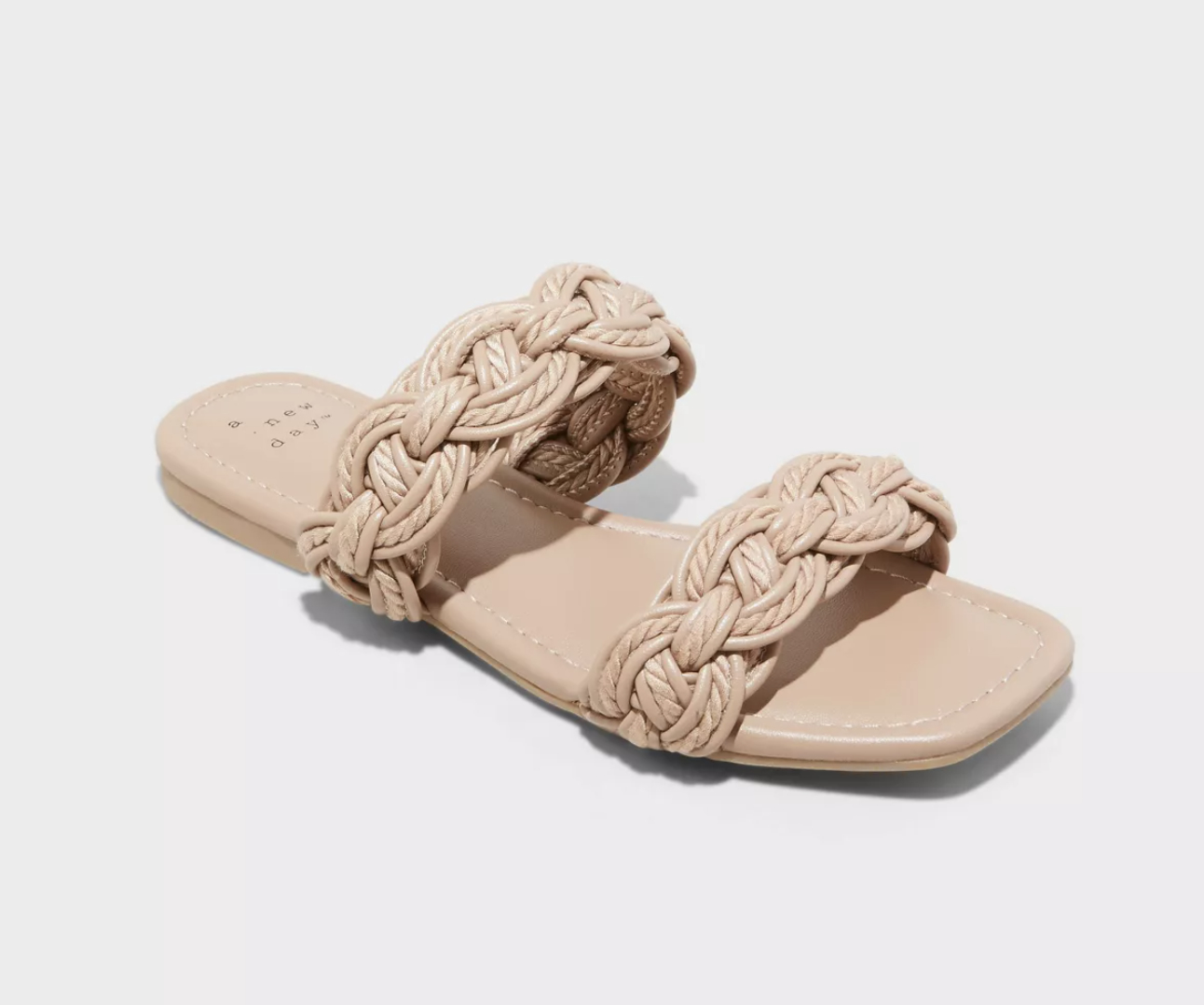 A pair of braided sandals on a plain background