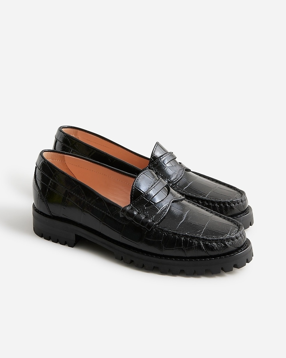 A pair of black loafers with chunky soles displayed against a neutral background