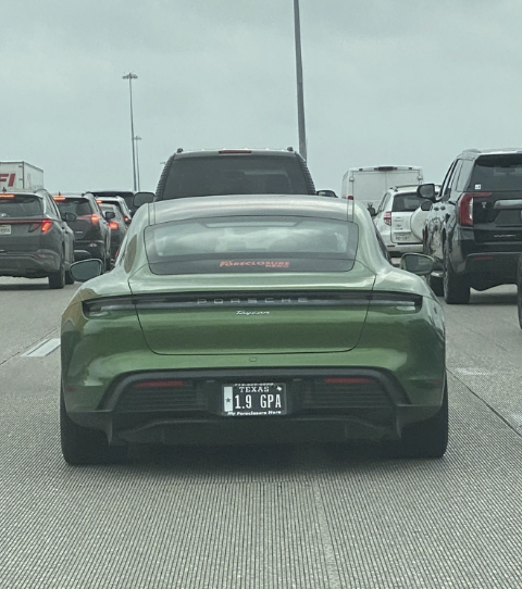 Rear view of a sports car with the license plate &quot;1.9 GPA&quot; in traffic