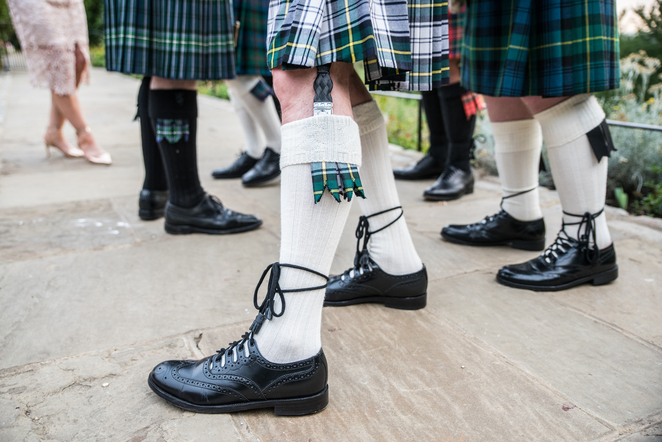 People in kilts and traditional Scottish attire at a wedding