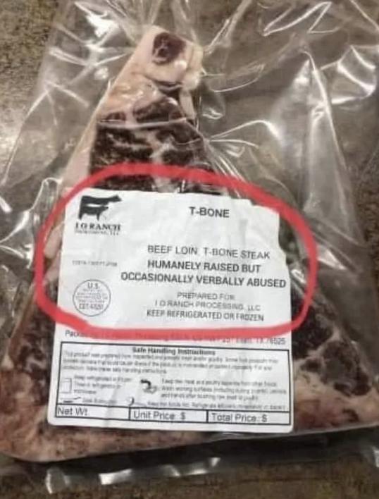 Packaged T-bone steak with a label jokingly stating &quot;humanely raised but occasionally verbally abused.&quot;