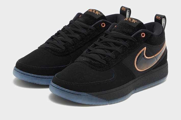 A pair of Nike SB Dunk High sneakers with a black upper, copper swoosh, and blue soles