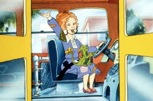 Animated character Ms. Frizzle with a lizard on her arm driving the Magic School Bus