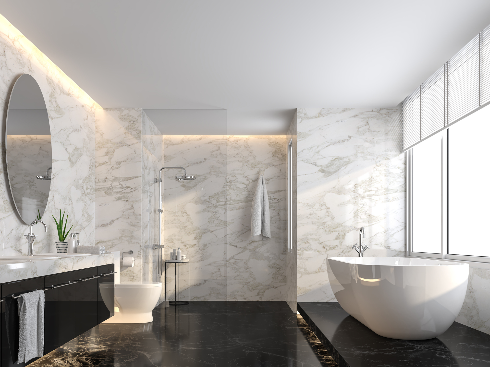 Modern bathroom with freestanding tub, sink, and mirror and marble walls and counters