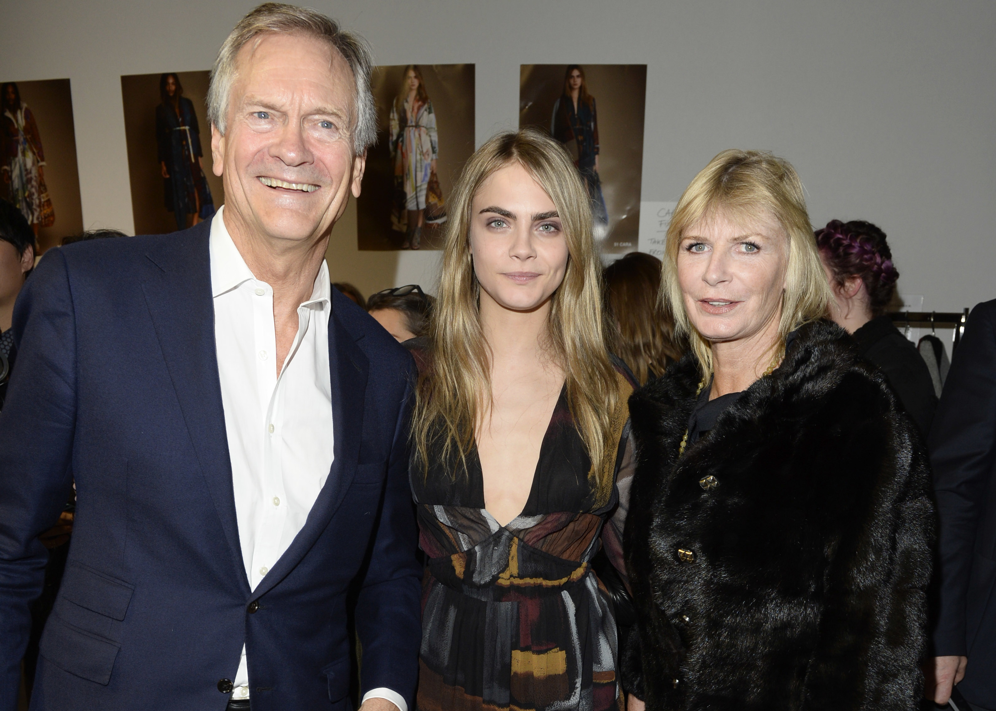 cara in the middle of her parents at an event