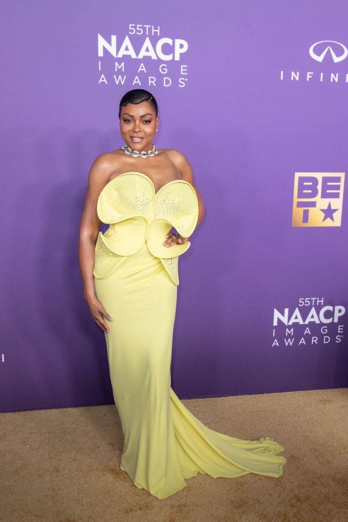 Taraji P. Henson stands on red carpet in unique yellow gown with large bow at the NAACP Image Awards