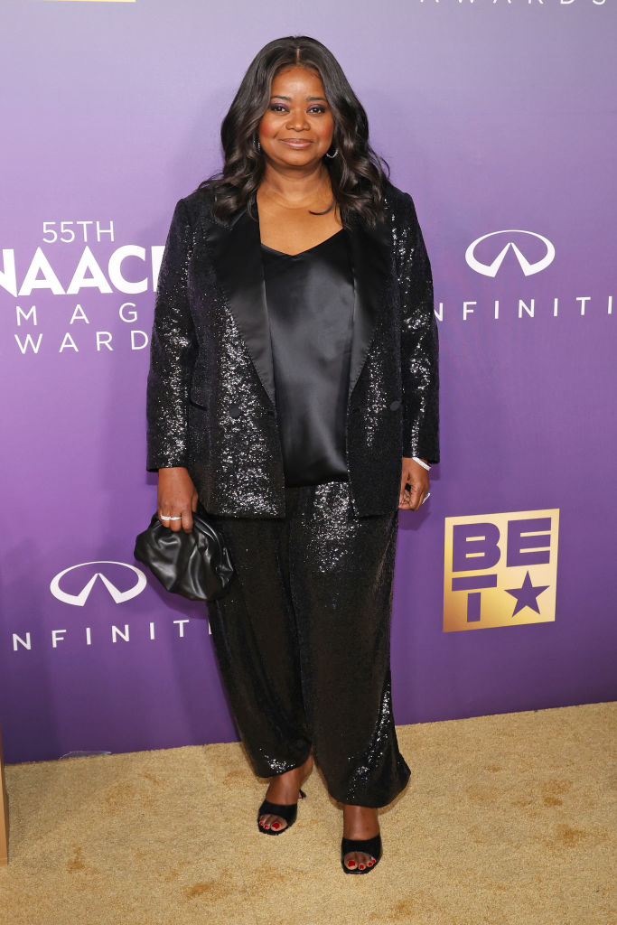 Octavia Spencer at an event wearing a black sequined suit and holding a clutch