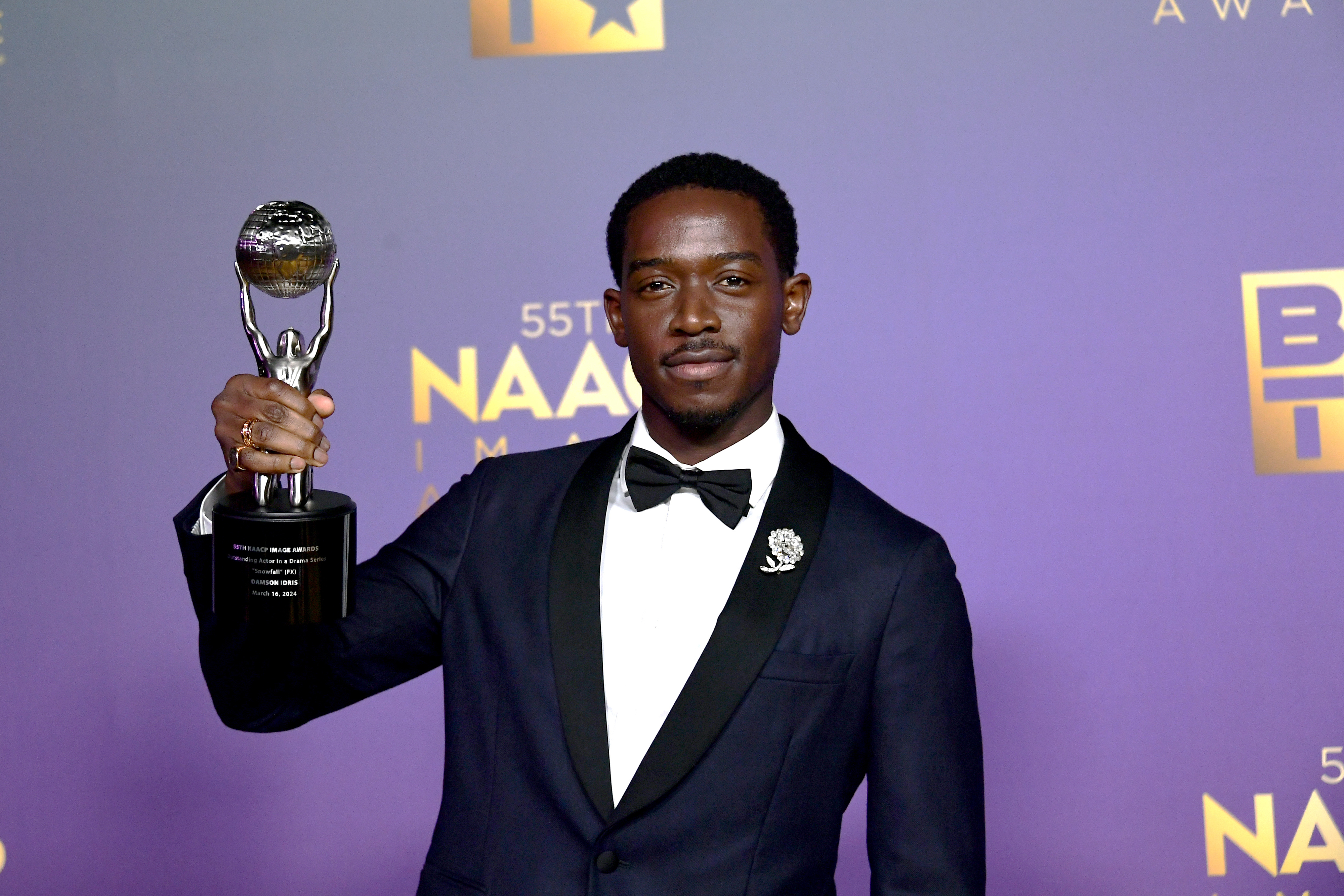 Damson Idris holding his NAACP Image award