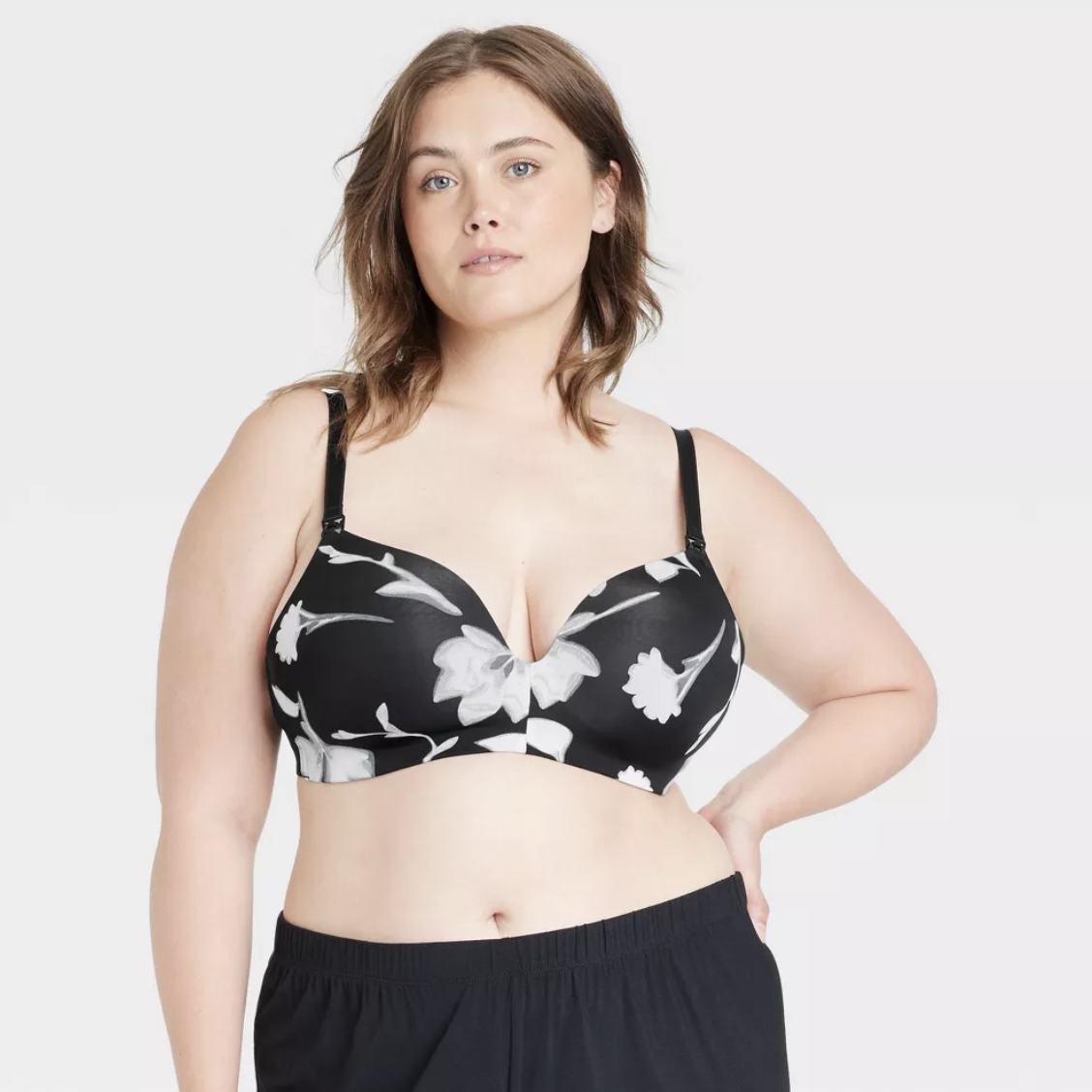 model wearing a black and white floral print nursing bra